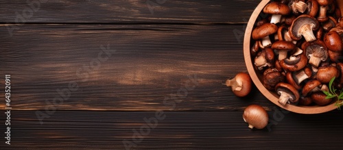 Shiitake mushrooms on a brown plate top view rustic wooden background