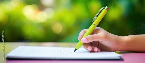 A woman s hand holds 3 pens...