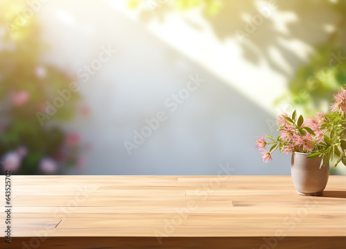 Abstract blank wooden tabletop over blurred green plant in garden background with morning sunlight