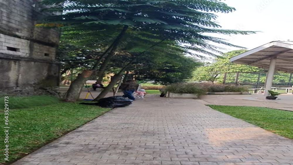 person walking in the park holding hands with child person walking in the park holding hands with child