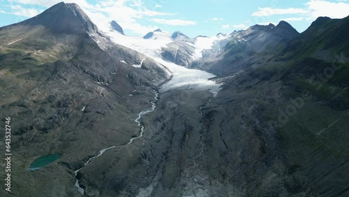 Glacier melting in the Alps. Global warming is melting the ice of the glaciers. Meltwater flows into the valley. Gries glacier Switzerland photo