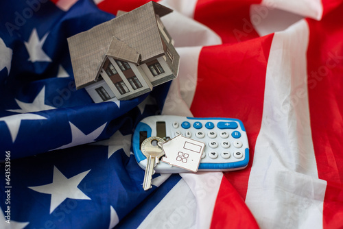 Unrated states of America flag and key with house keychain. Concept of buying or renting home photo