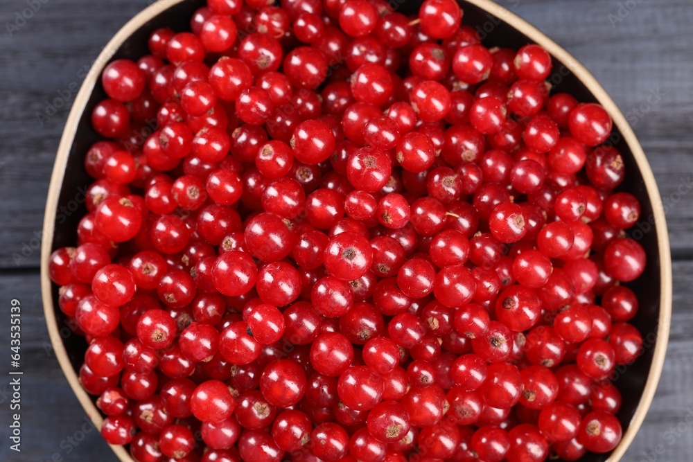 Ripe red currants in bowl on wooden rustic table, top view Ripe red currants in bowl on wooden rustic table, top view