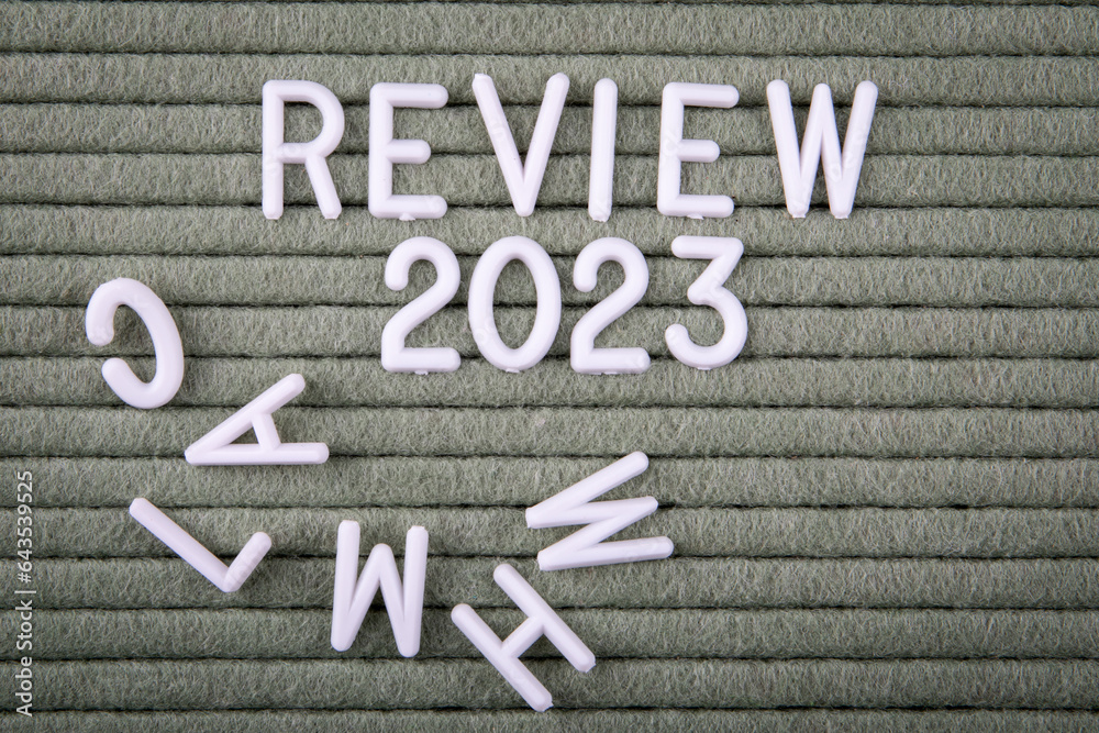 REVIEW 2023 Concept. White letters of the alphabet on a green ...