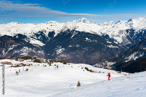 Ski resort in winter Alps mountains, France. Skiers ride on the ski slope. Courchevel, France. © smallredgirl