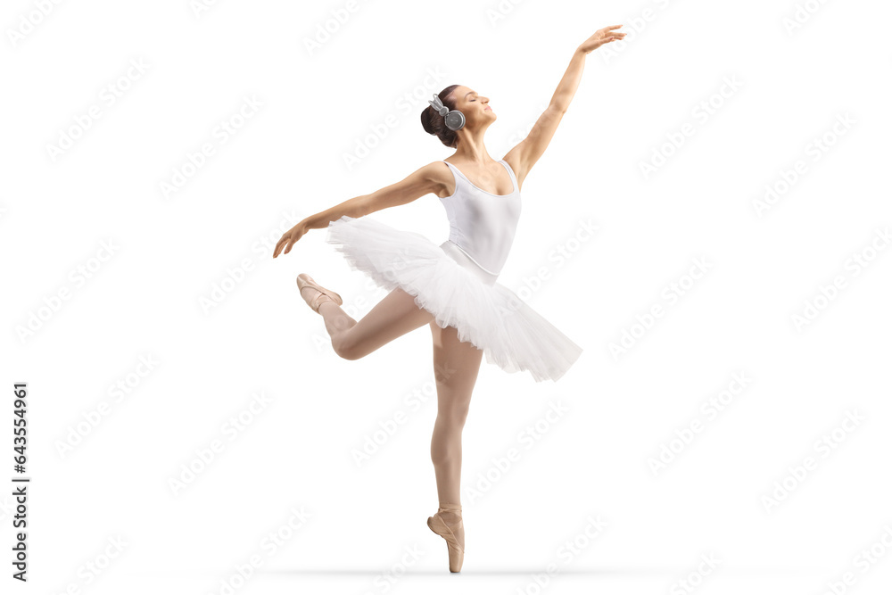 Full length profile shot of a ballerina with headphones dancing