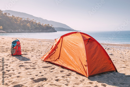 Embracing the coastal charm of the Lycian Way  a camping tent stands proudly on a serene beach  ready for an unforgettable outdoor experience.