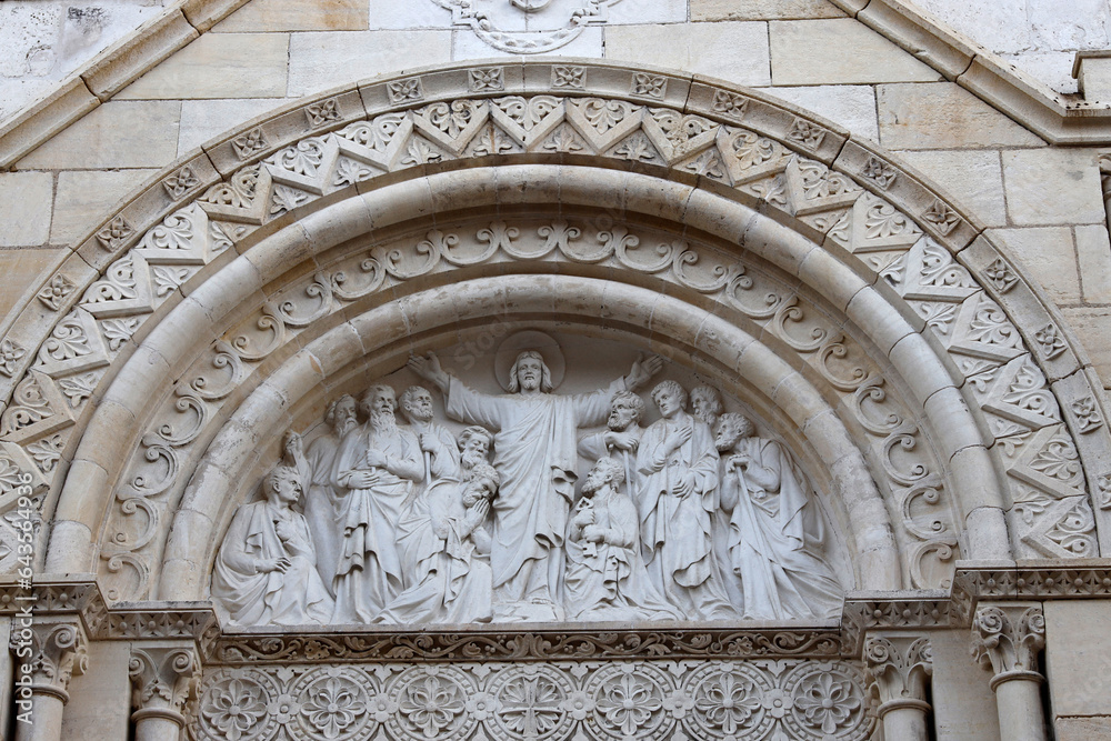 Sancerre village, Berry, France. Notre Dame church tympanum depicting Jesus with disciples.