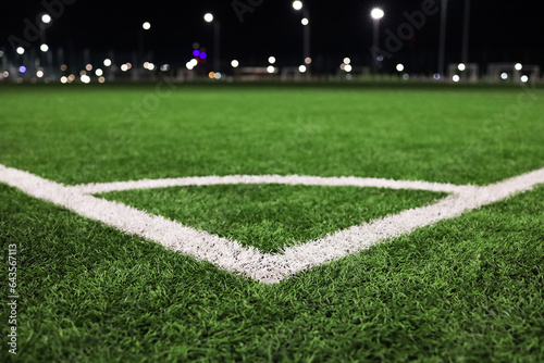 Fotografi A green field at a football stadium with markings