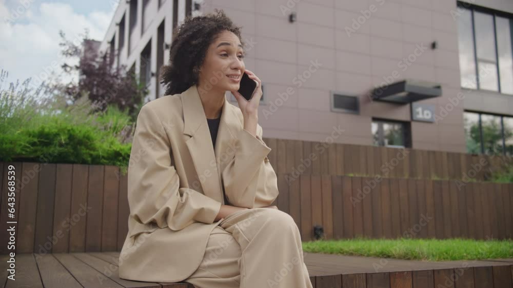 Woman Phone Call Conversation on Park Bench in Downtown Woman Phone Call Conversation on Park Bench in Downtown