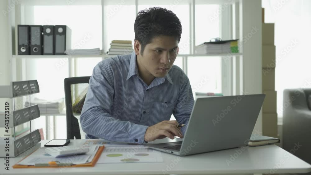 Young Asian businessman doing accounting work with calculator to calculate income and expenses, taxes, bills, credit cards for payment or pay the date at home, at work, financial concepts, Young Asian businessman doing accounting work with calculator to calculate income and expenses, taxes, bills, credit cards for payment or pay the date at home, at work, financial concepts,