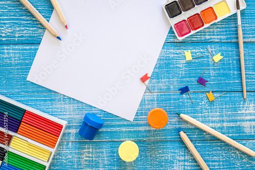 Flat lay school stationery on a wooden background, back to school concept, copy space.