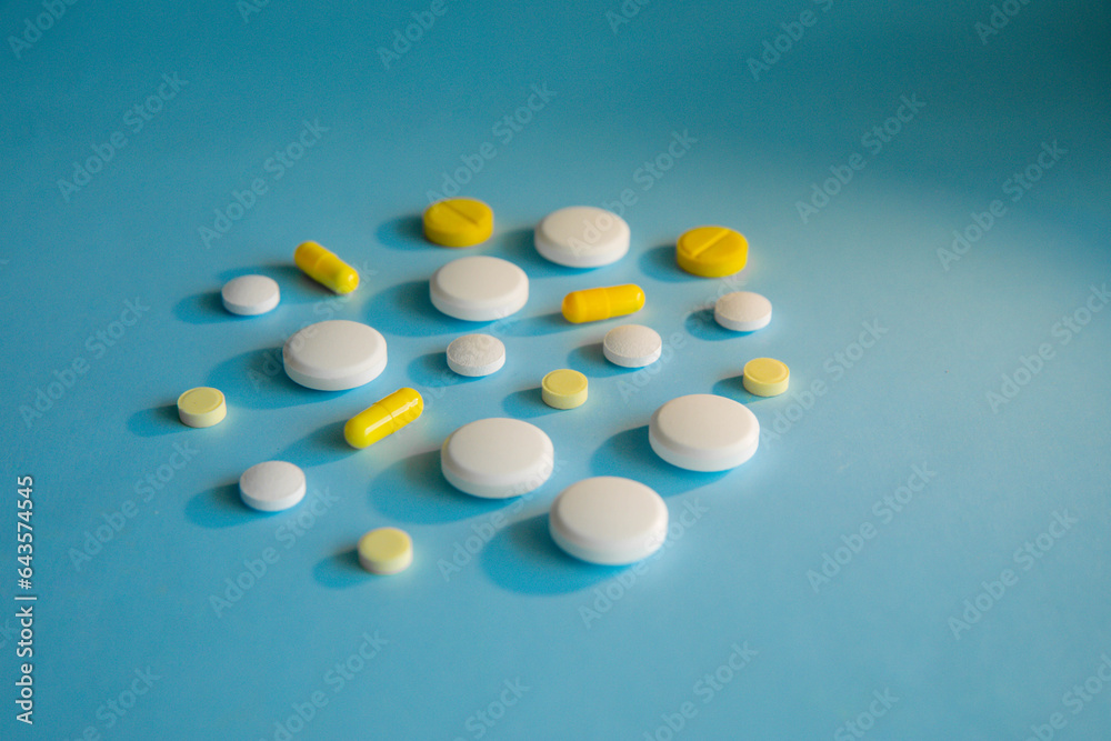 White and yellow tablets on a blue background White and yellow tablets on a blue background