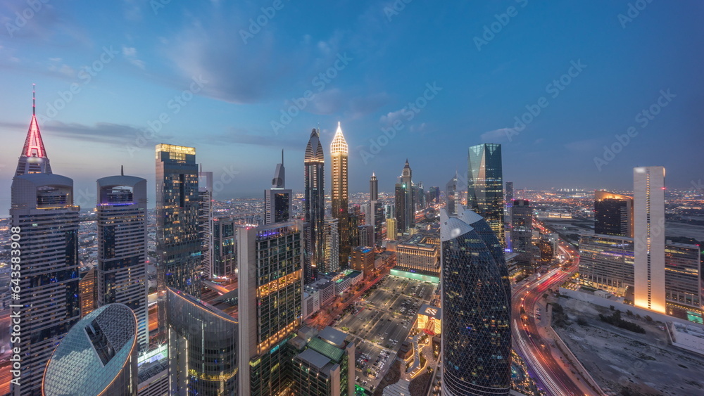 Skyline view of the high-rise buildings on Sheikh Zayed Road in Dubai aerial day to night timelapse, UAE. - obrazy, fototapety, plakaty 