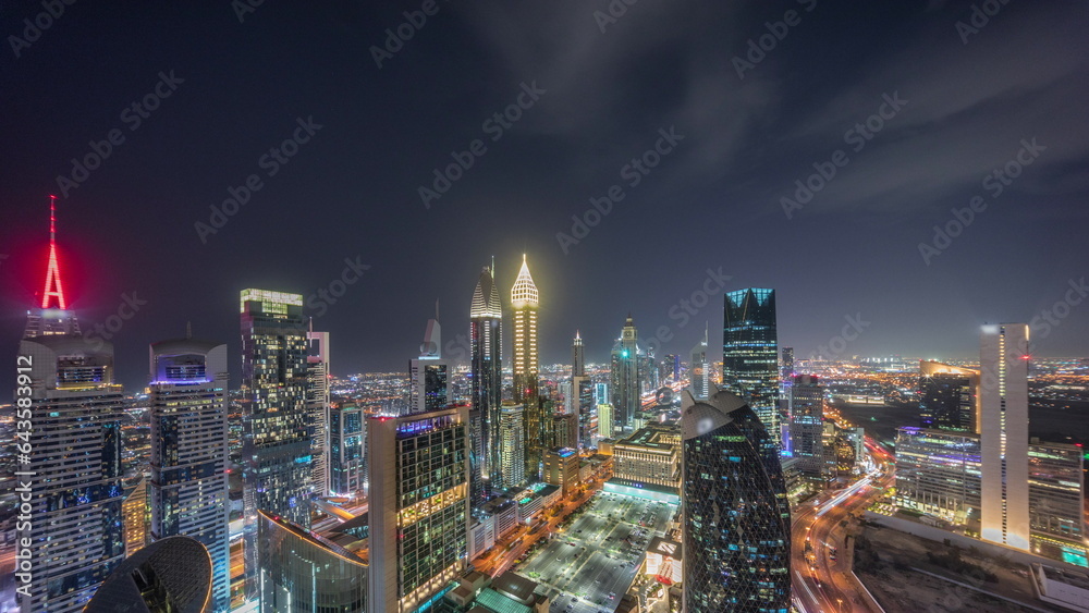 Naklejka premium Skyline view of the high-rise buildings on Sheikh Zayed Road in Dubai aerial night timelapse, UAE.