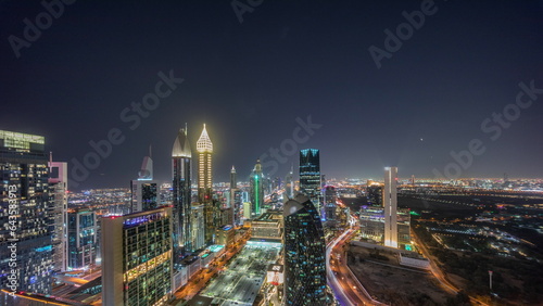 Skyline panoramic view of the high-rise buildings on Sheikh Zayed Road in Dubai aerial night timelapse, UAE.