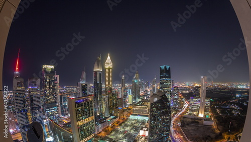 Skyline panorama of the high-rise buildings on Sheikh Zayed Road in Dubai aerial night timelapse  UAE.