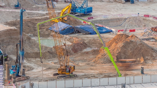 Canvas Print Pile driving in foundation pit for construction of apartment complex building ae