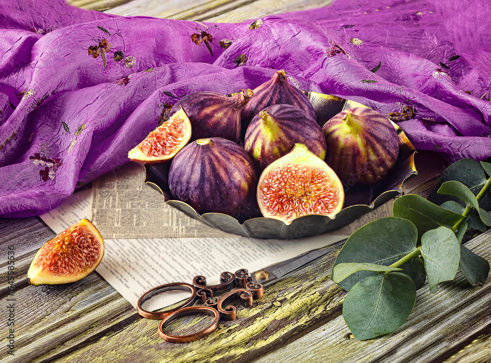 Fresh ripe figs in vintage plate, green eucalyptus branch, viney
