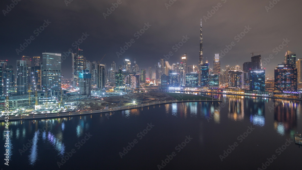 Obraz premium Aerial view to Dubai Business Bay and Downtown with the various skyscrapers and towers night timelapse