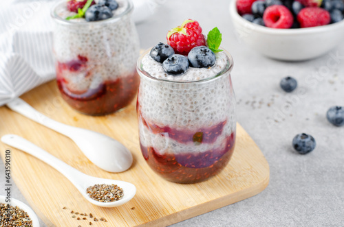 Healthy Chia Pudding in a Glass with Raspberry Jam and Fresh Berries