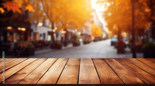 Empty wooden table top with blur background of city street in autumn