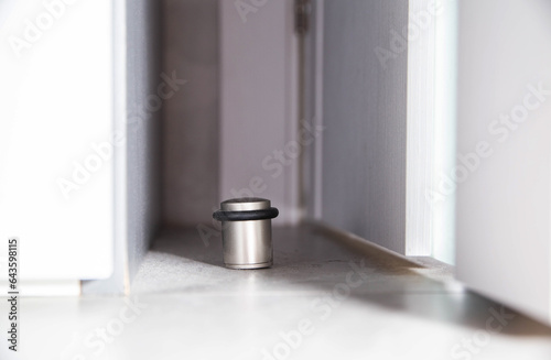 The floor door stop restricts the movement of the interior door from hitting the wall. photo