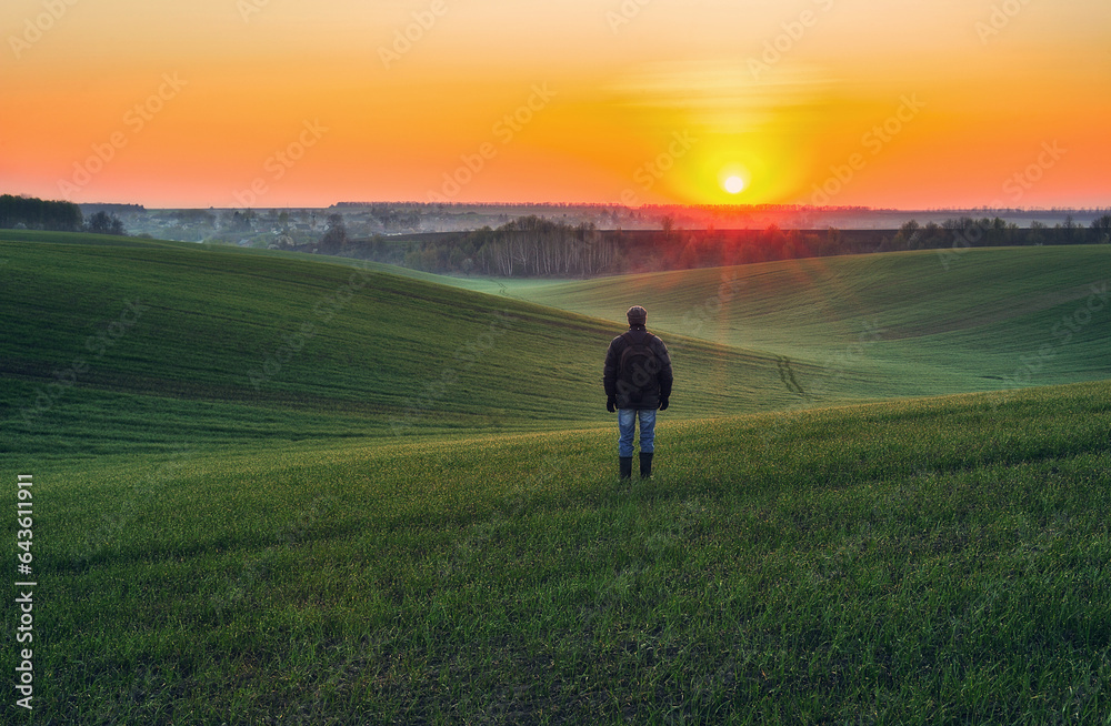 tourist walks on a green field. picturesque hills. nature of Ukraine
