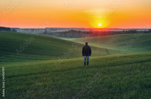 tourist walks on a green field. picturesque hills. nature of Ukraine