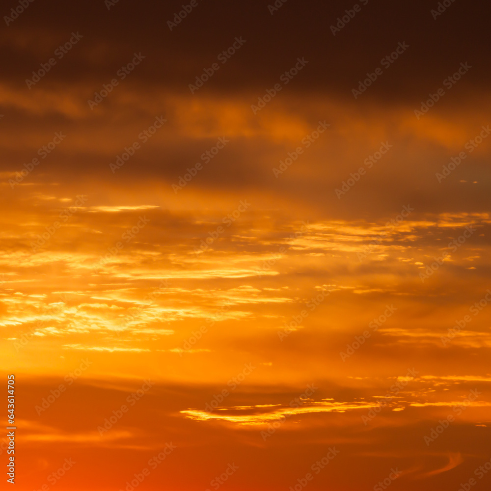 Obraz premium Bright vibrant orange and yellow colors sunset sky
