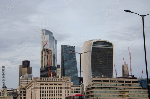 A few buildings and skyscrapers of the City district in London, with some being under construction, on a winter end of afternoon, viewed from the London bridge.