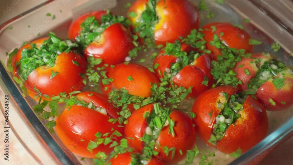 Stuffed pickled tomatoes lie in glass container. Stuffed pickled tomatoes lie in glass container.