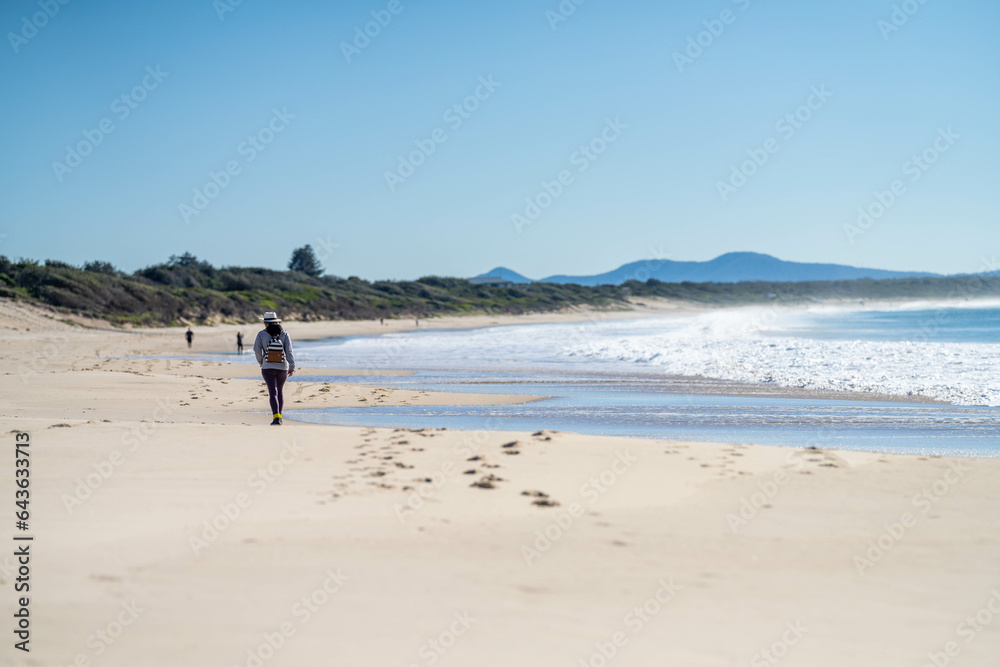 walking on the beach at dusk on an australian sandy beach