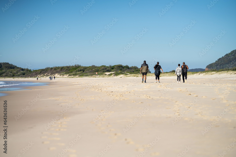 walking on the beach at dusk on an australian sandy beach walking on the beach at dusk on an australian sandy beach