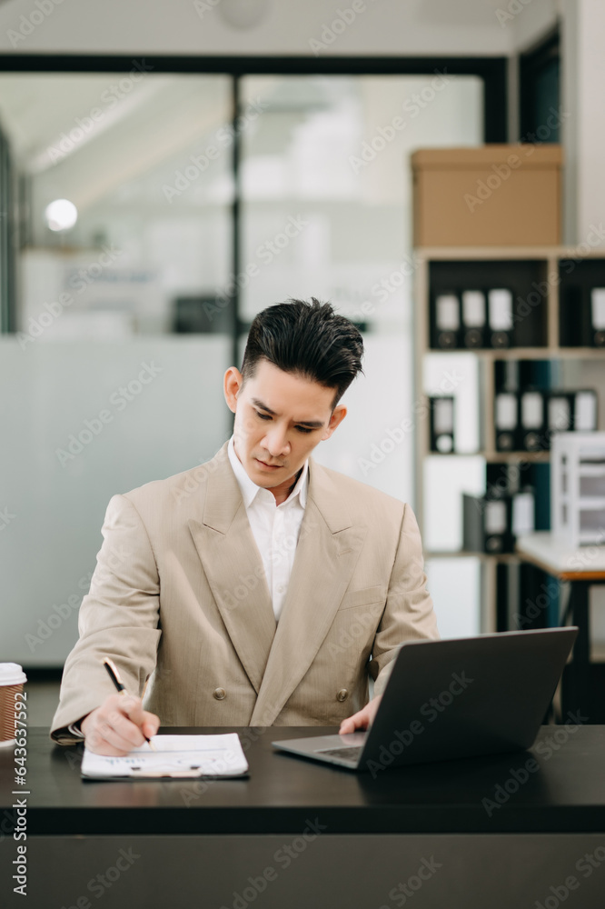 Mature business man executive manager looking at laptop watching online webinar training or having virtual meeting video conference doing market research working in office.. Mature business man executive manager looking at laptop watching online webinar training or having virtual meeting video conference doing market research working in office..