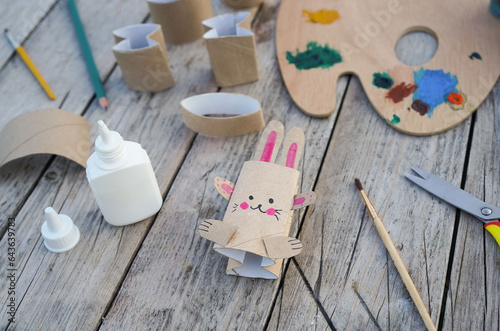 Kids craft bunny out of recycling toilet paper roll, zero waste concept. photo