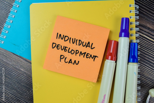 Concept of Individual Development Plan write on sticky notes isolated on Wooden Table.