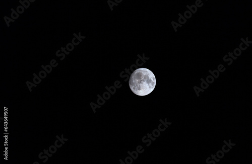 View of the full moon at the time of the blue full moon on August 29, 2023, the second full moon of the month. Night sky landscape with a satellite of the Earth against a black sky photo