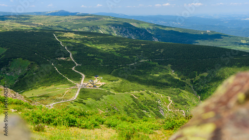 Fototapeta Naklejka Na Ścianę i Meble -  Giant Mountains, mountain panorama from the hiking trail to the top of Sniezka. View of the vast mountain slopes and trails on a sunny summer day.