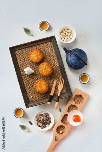 Flat lay Mid-autumn festival food and drinks - mooncake and tea set on white background.