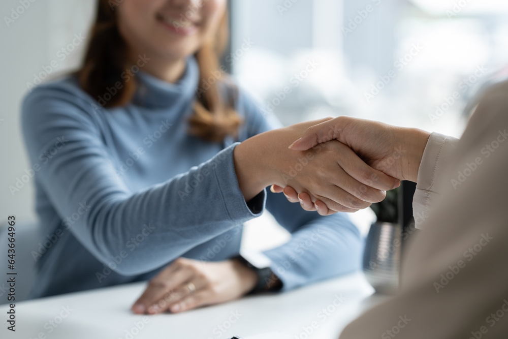 Businesswoman, office worker shaking hands, investing and expressing joy of cooperation. Successful business in real estate discussing contract documents financial and tax system concepts. Businesswoman, office worker shaking hands, investing and expressing joy of cooperation. Successful business in real estate discussing contract documents financial and tax system concepts.
