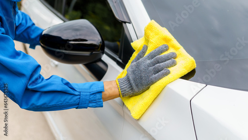 Wallpaper Mural Man cleaning the car with a clean cloth, washing the car, wiping the car, polishing the car, wiping dust Torontodigital.ca