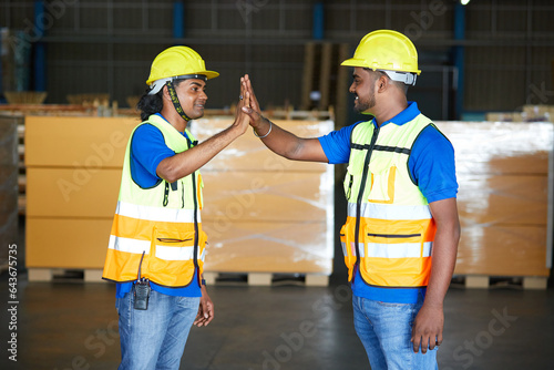 workers giving high five pose in the warehouse storage