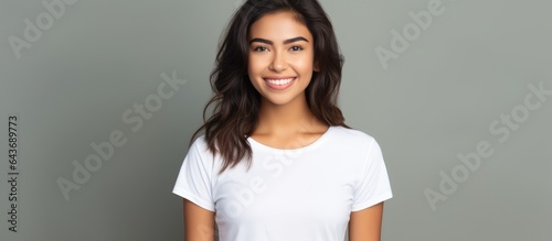 Isolated young Hispanic woman in white t shirt with background for copy space