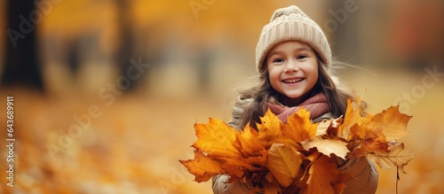 Young girl gathers autumn l...