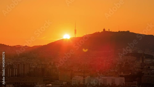 Dawn over Tibidabo mountain and Barcelona city skyline