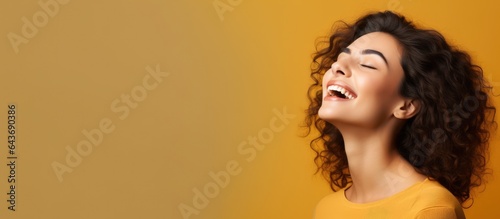 Excited young woman calling out happy and looking towards empty space beside
