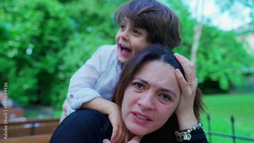 Careless small boy choking mom while playing. Kid not knowing play limits, upset mother, real life Careless small boy choking mom while playing. Kid not knowing play limits, upset mother, real life