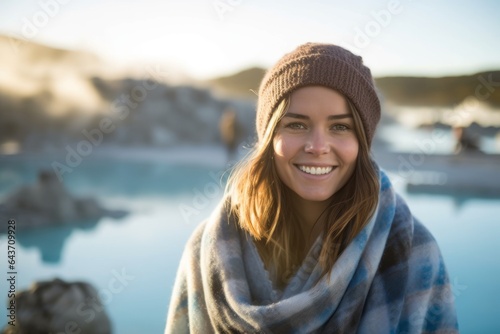Medium shot portrait photography of a grinning girl in her 30s wearing a gorgeous silk scarf at the blue lagoon in reykjavik iceland. With generative AI technology