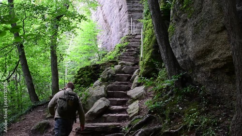 Rimrock rock steps going up the cliff rock wall hiking destination Allegheny state park, inside dark forest, fall season. photo